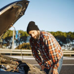 river at a Kensington petrol station carefully checking fuel nozzle before refuelling.