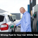 driver putting wrong fuel in car at petrol station while travelling UK