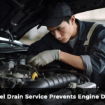 mechanic performing on-site fuel drain service to prevent engine damage after wrong fuel mistake in UK