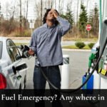 driver at petrol station realising wrong fuel mistake emergency in UK while holding fuel pump